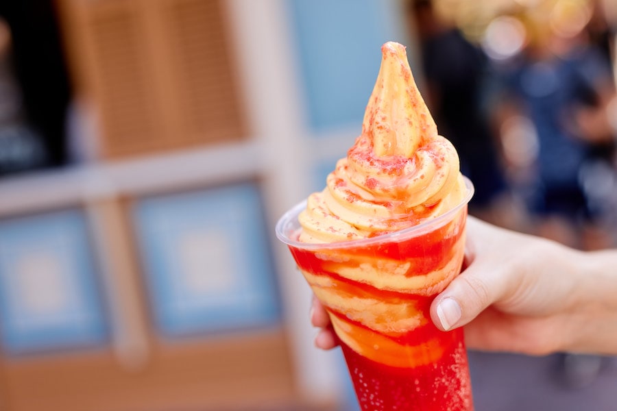 Magic Kingdom Park, Sunshine Tree Terrace (Currently available; mobile order available) - I Lava You Float: Fanta Strawberry and passion fruit flavor served with DOLE Whip Orange and topped with popping candy (Plant-based)