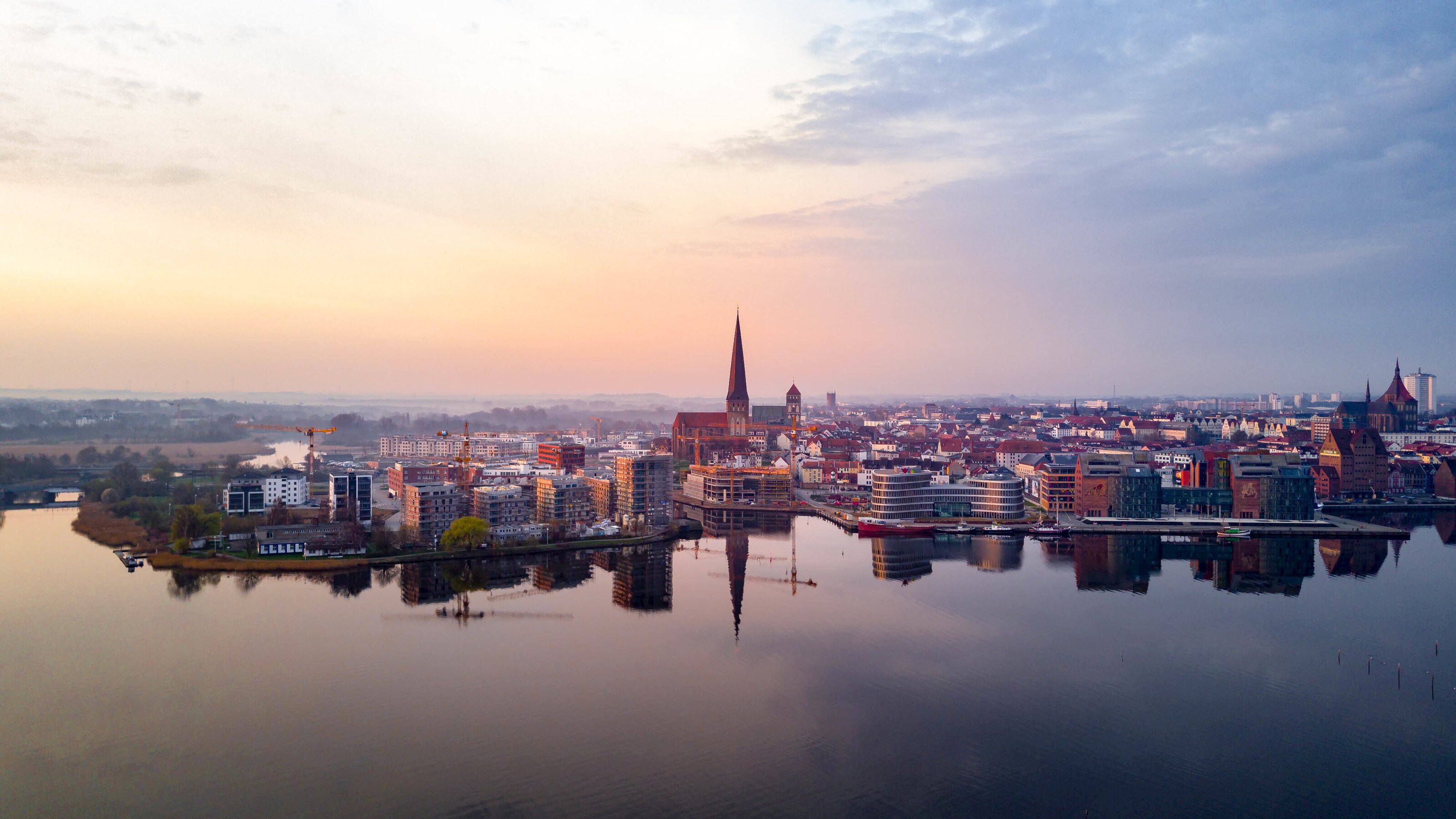 The Rostock shoreline reveals still waters, a large steeple and a mix of old and modern architecture