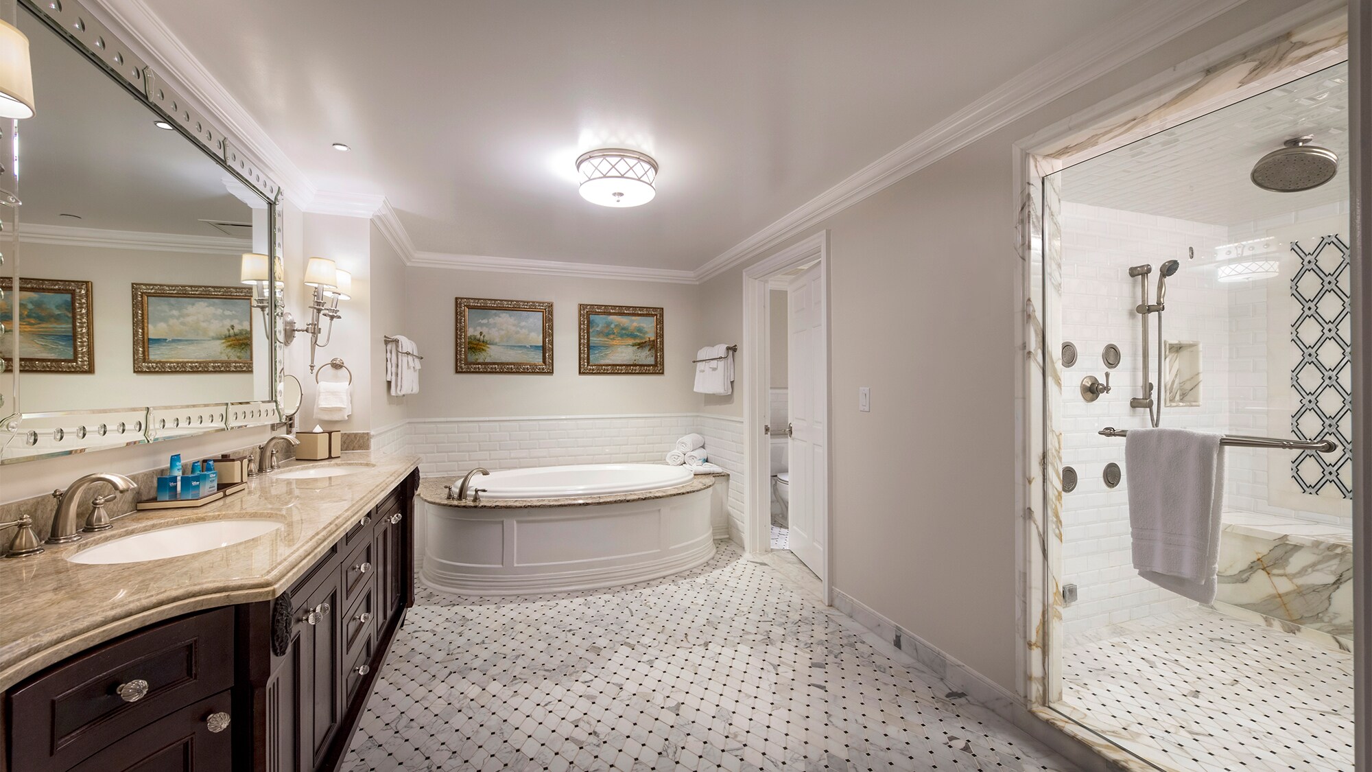 A bathroom with a dual sink, a tub and a shower