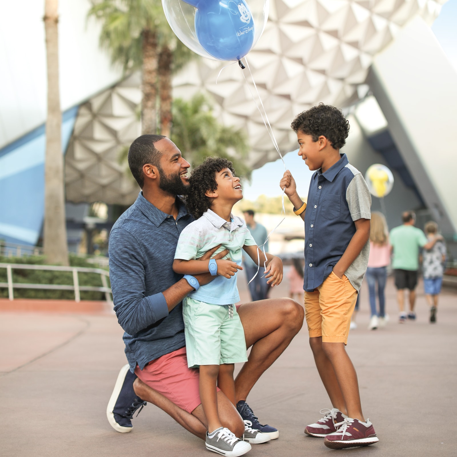A dad at Epcot with his 2 sons