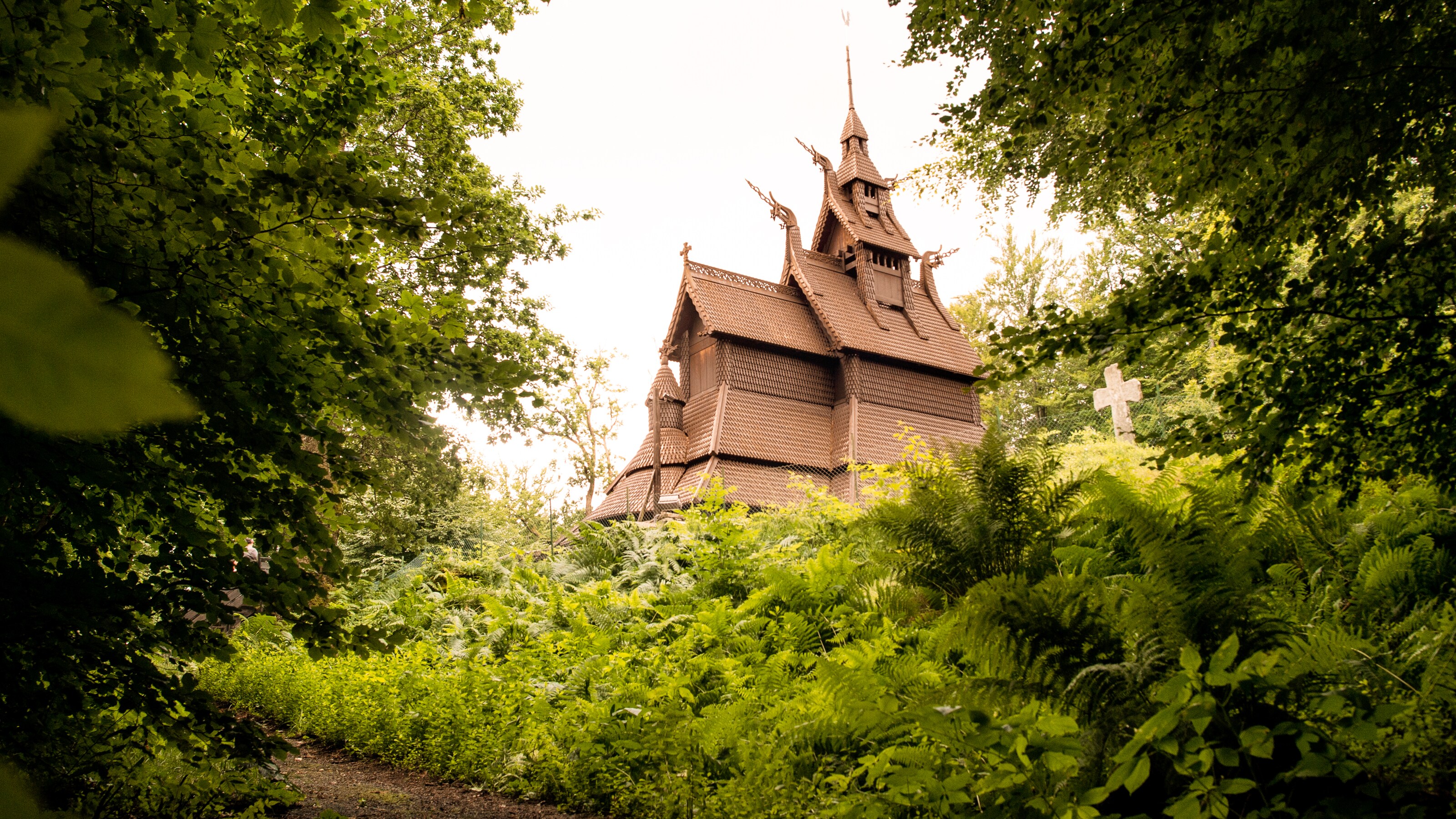 A wooden church with scaled shingles and gables carved to look like dragon's heads