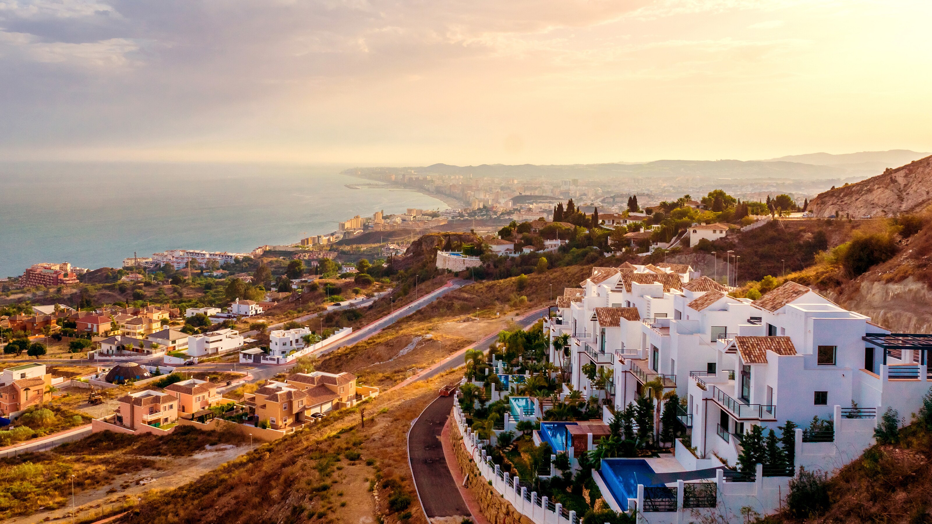 Pristine homes dot the hillsides of southern Spains Malaga, with the rest of the city nestled below