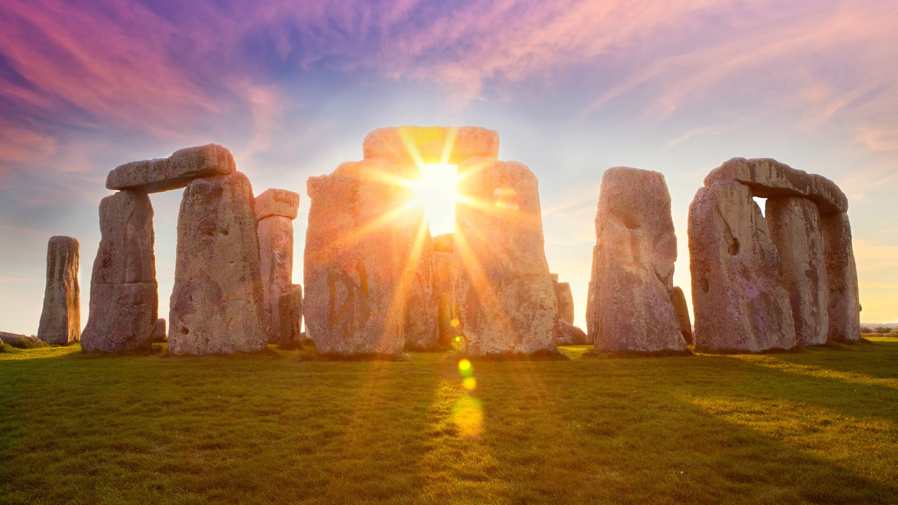 The sun peeking through Stonehenge