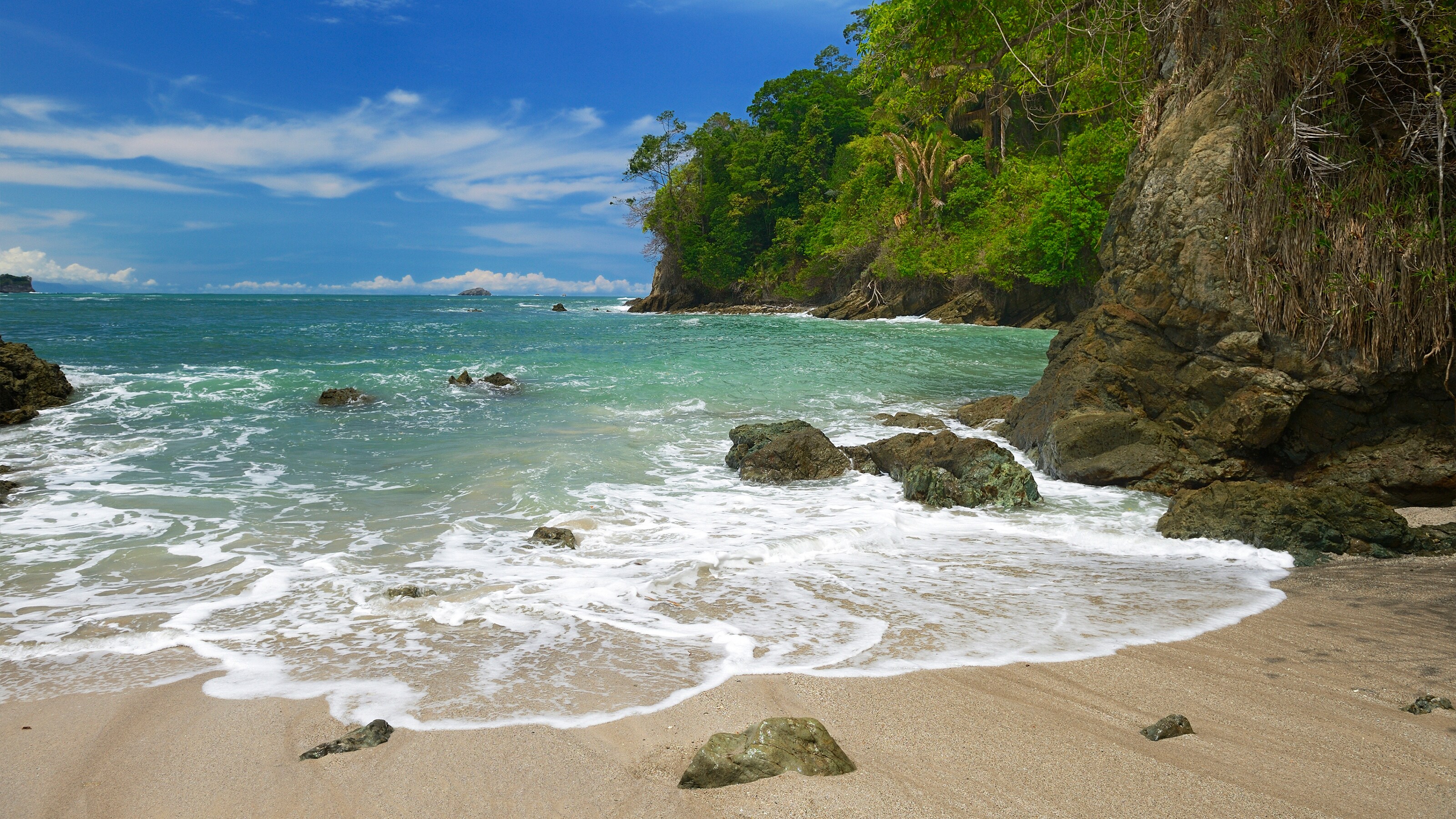The shoreline of Manuel Antonio National Park on Costa Rica’s central Pacific Coast reveals rugged rainforest and a sandy beach
