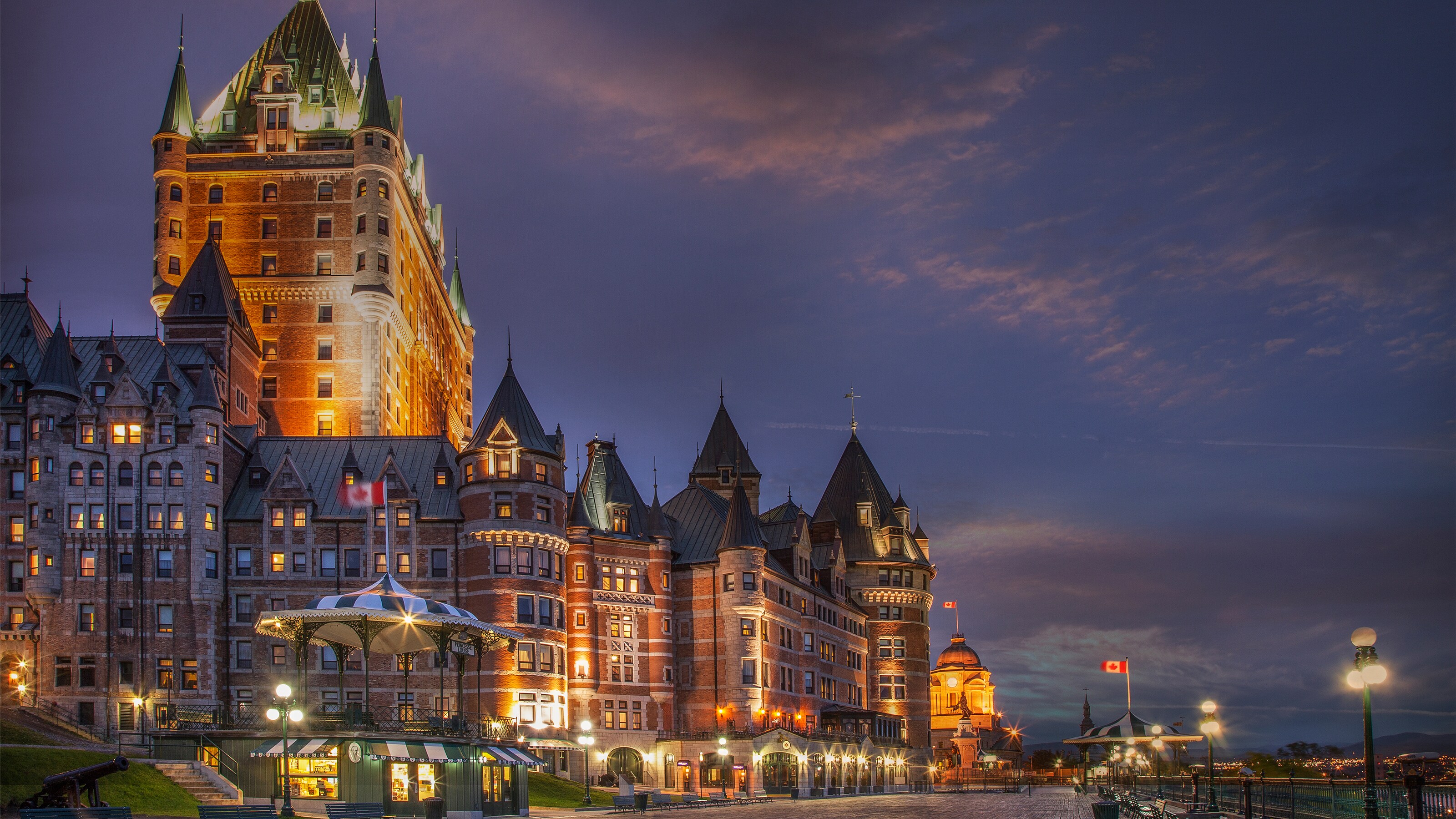 A brickwork hotel surrounded by streetlights and a Canadian flag