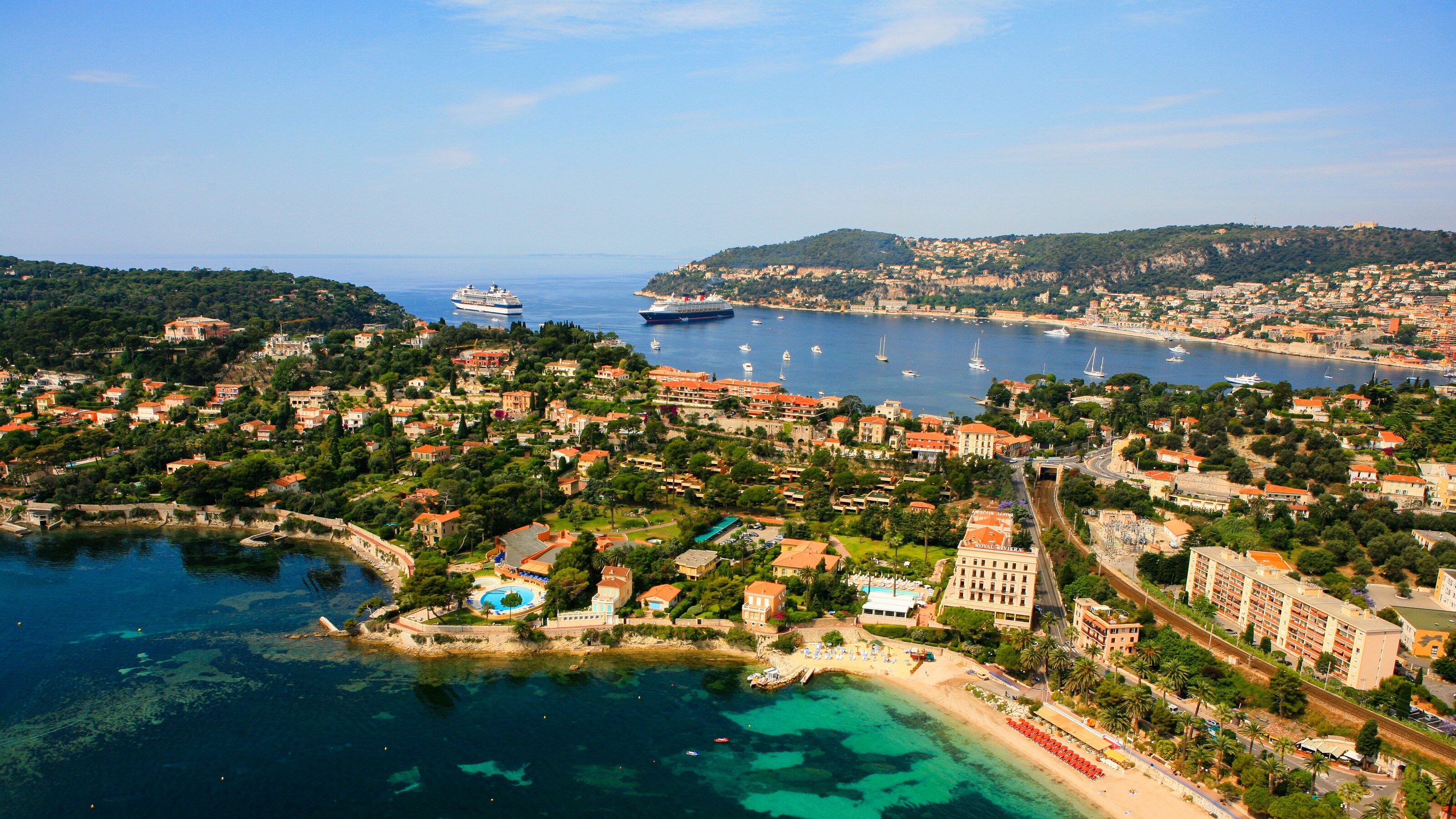 Two tropical peninsulas populated by builidings surround a bay