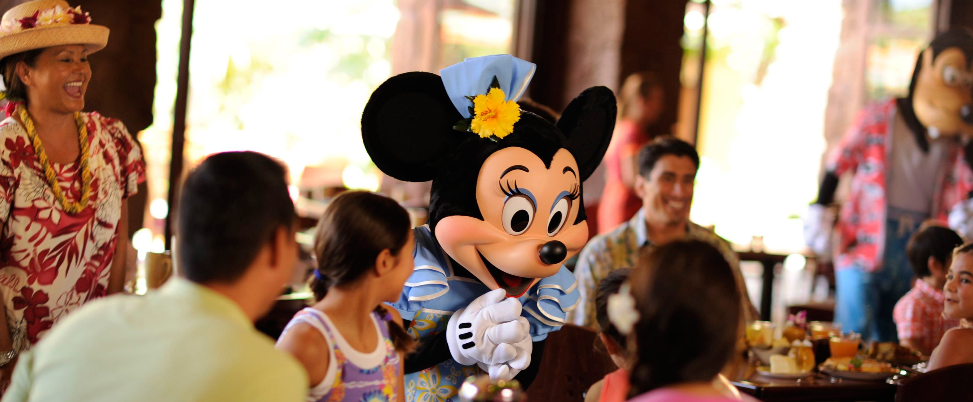 Minnie Mouse meets a family during Aunty's Breakfast Celebration at the Makahiki