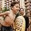 A father holding an inner tube and his son wearing swim trunks stand beside a rock at Aulani Resort
