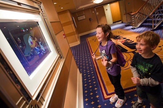 Children pause to watch framed artwork come to life – a special Disney Dream feature called Enchanted Art