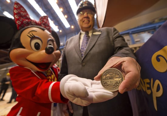 Karl Holz, President of Disney Cruise Line and Minnie Mouse get ready to place the coin in the keel for the Disney Fantasy.