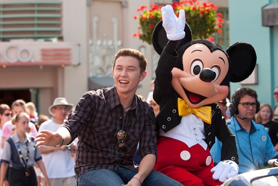 (MAY 30, 2011): Newly crowned 'American Idol' Scotty McCreery takes a celebratory ride May 30, 2011, with Mickey Mouse through Disney's Hollywood Studios in Lake Buena Vista, Fla. Scotty was honored in a parade at the Disney theme park and performed his new single 'I Love You This Big.' On Wednesday, the 17-year-old singer was crowned the new 'American Idol' on the season finale which was viewed by an estimated 29.3 million people. (Matt Stroshane, photographer)