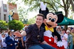 (MAY 30, 2011): Newly crowned 'American Idol' Scotty McCreery takes a celebratory ride May 30, 2011, with Mickey Mouse through Disney's Hollywood Studios in Lake Buena Vista, Fla. McCreery was honored in a parade at the Disney theme park and performed his new single 'I Love You This Big.' On Wednesday, the 17-year-old singer was crowned the new 'American Idol' on the season finale which was viewed by an estimated 29.3 million people. (Matt Stroshane, photographer)