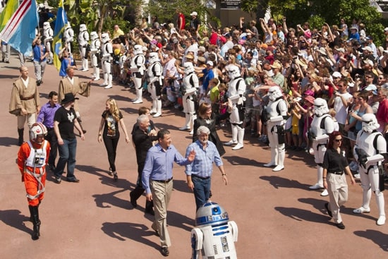 Walt Disney Co. president and CEO Bob Iger (left) waves as he walks with 'Star Wars' creator George Lucas through Disney's Hollywood Studios theme park in Lake Buena Vista, Fla. May 20, 2011 during grand opening ceremonies for 'Star Tours -- The Adventures Continue,' a new 3-D attraction based on the 'Star Wars' films. The attraction, which features more than 50 possible random ride experiences, opened May 20, 2011 at Walt Disney World in Florida and will open June 3, 2011 at Disneyland Resort in California. (Matt Stroshane, photographer)