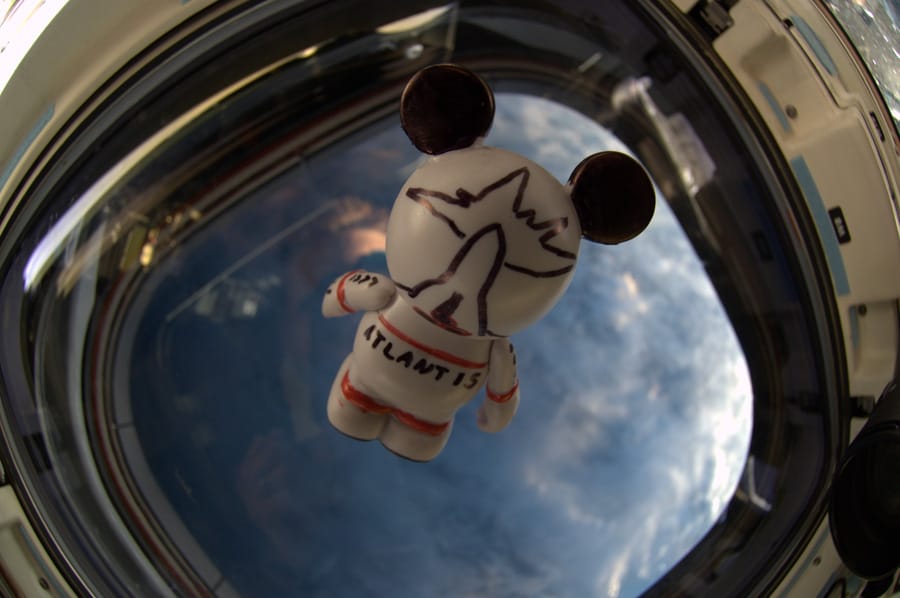 The 'Create-Your-Own' Vinylmation, with artwork created by the astronauts aboard STS-132, looks to the Earth as it floats inside Space Shuttle Atlantis
