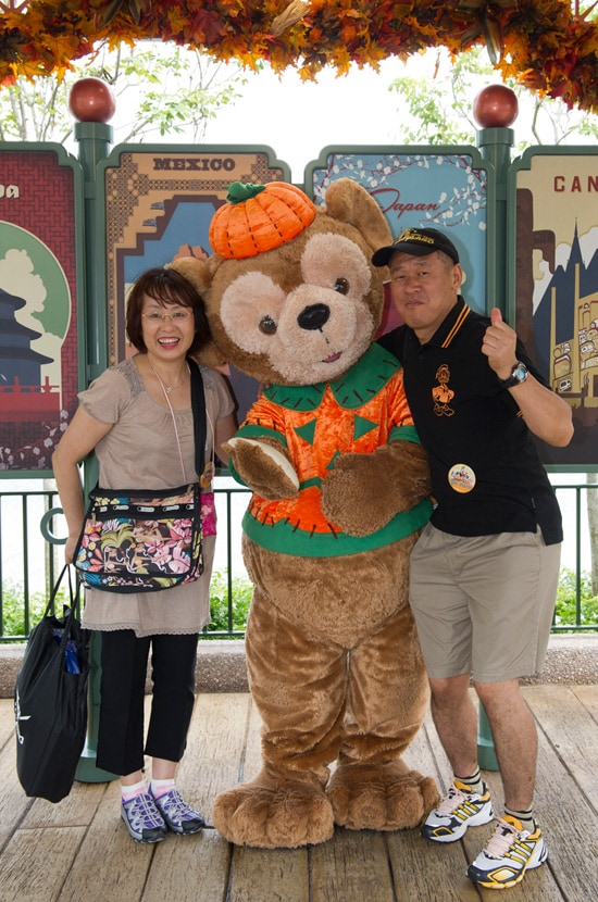 Mr. and Mrs. Noriake Sakata with Duffy the Disney Bear in his Halloween Costume at Epcot