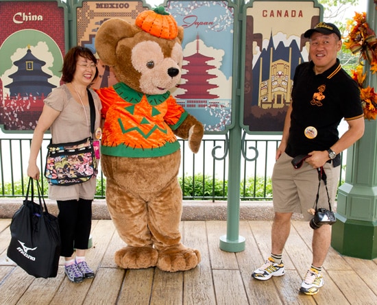 Mr. and Mrs. Noriake Sakata with Duffy the Disney Bear in his Halloween Costume at Epcot