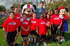 Super Bowl MVP from the New York Giants Eli Manning with Mickey Mouse, Minnie Mouse and Play 60 Members at Walt Disney World Resort