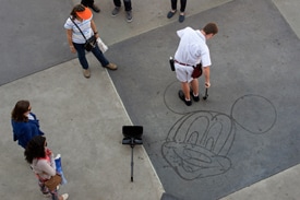Hayes is One of 15 or so Cast Members Who Has Learned to ‘Paint’ Mickey, Minnie and Other Classic Disney Characters Using Nothing More Than His Broom and Water