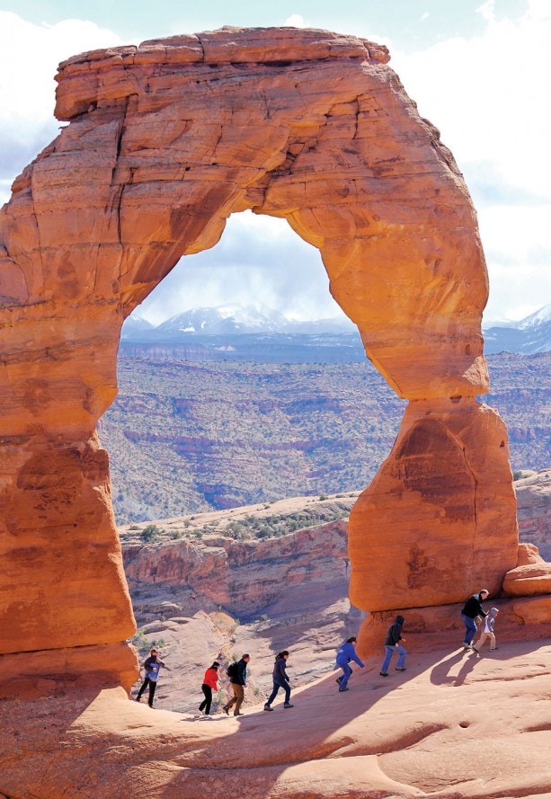 : These Hikers Walk Through Arches National Park as a Part of Their Adventures by Disney Arizona and Utah Itinerary