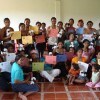 These artisans are holding their certificates of completion after completing a training session on how to create the plush