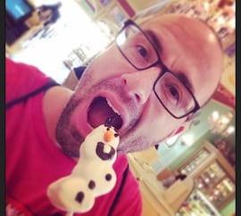 Disney Parks Blog Author Nate Rasmussen Enjoying an Olaf Marshmallow Pop from Disney California Adventure Park