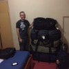 Vet tech Matt Runnells poses near the luggage he had to carry in to GRACE!