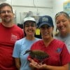 The Disney team includes (from left) Paul Schutz, zoological manager; Lidia Castro, veterinary technician; Leanne Blinco, Animal Health zoological manager; and Dr. Deidre Fontenot, Operations manager for the Animal Health team, with Staples, one of the outreach education birds.