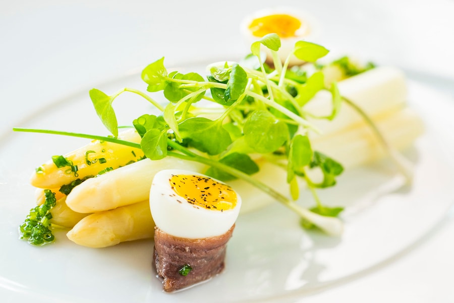 white asparagus with smoked anchovies, quail egg and truffle oil from Palo on Disney Cruise Line ships