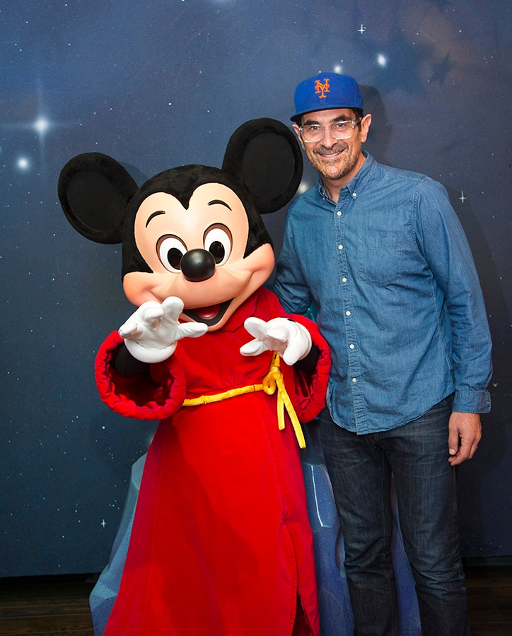 Actor Ty Burrell meets with Mickey Mouse during a visit to Disneyland Park 