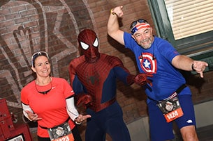 Spiderman poses with runners at the Avengers Half Marathon