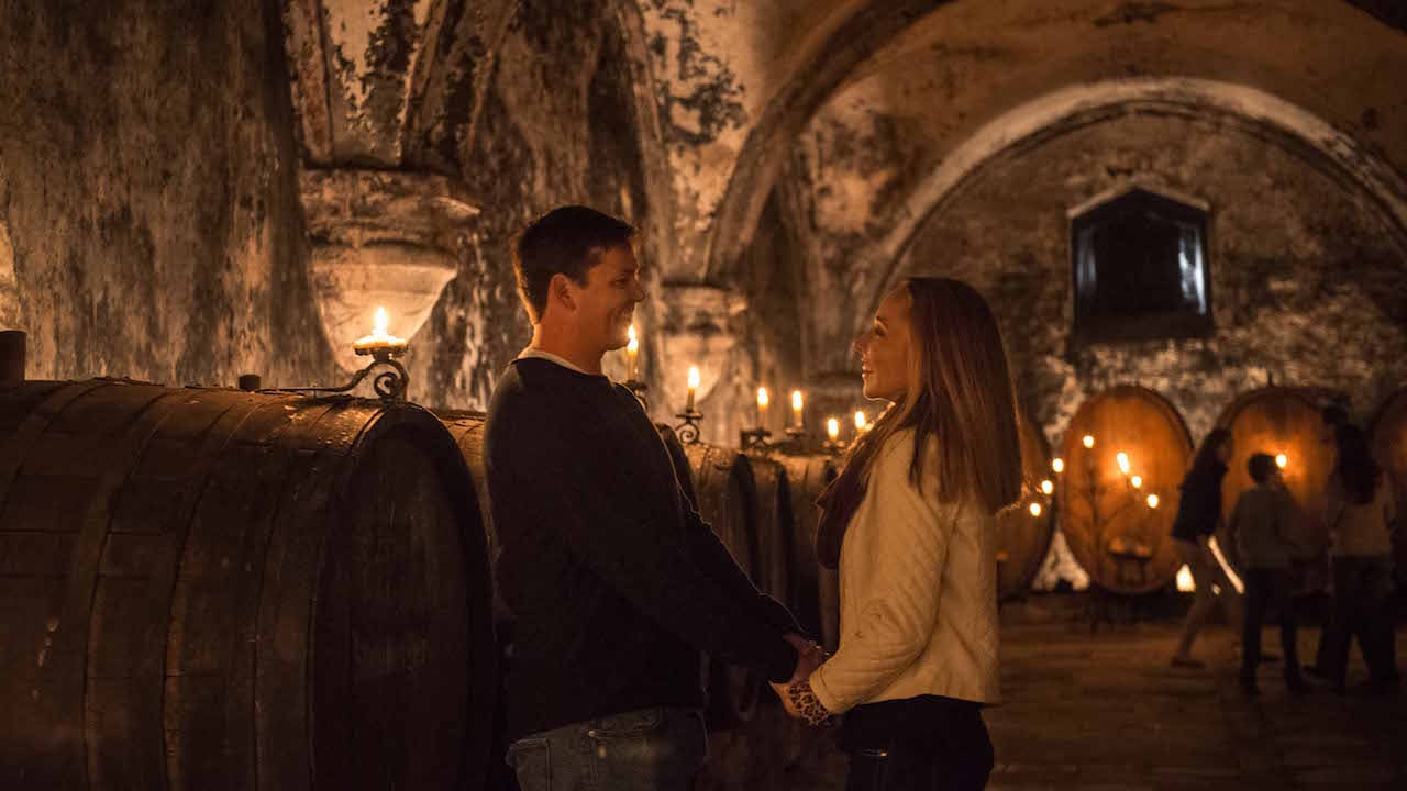 Couple exploring a wine cellar