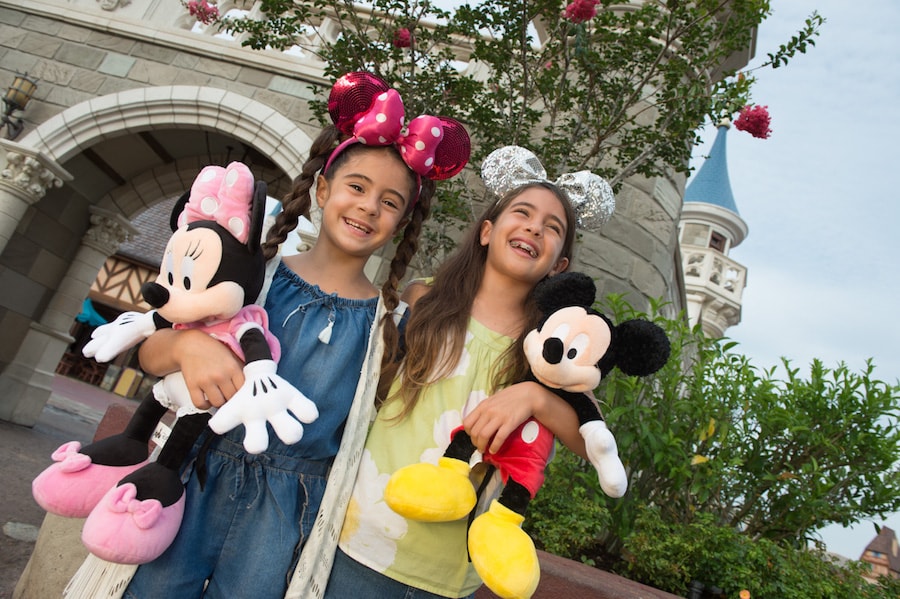 Girls with Mickey and Minnie Plushes at Magic Kingdom Park