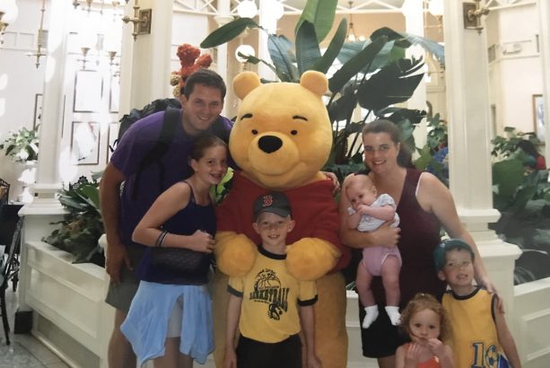 Disney Parks Moms Panelist Kaylene and her family with Pooh at The Crystal Palace