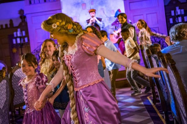 Rapunzel dances with guests at Rapunzel's Royal Table restaurant aboard the Disney Magic