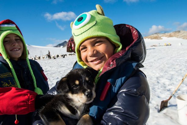 Cuddle with puppies on Dog Sled Port Adventures with Disney Cruise Line in Alaska