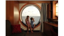 Kids looking out a window on Disney Cruise Line