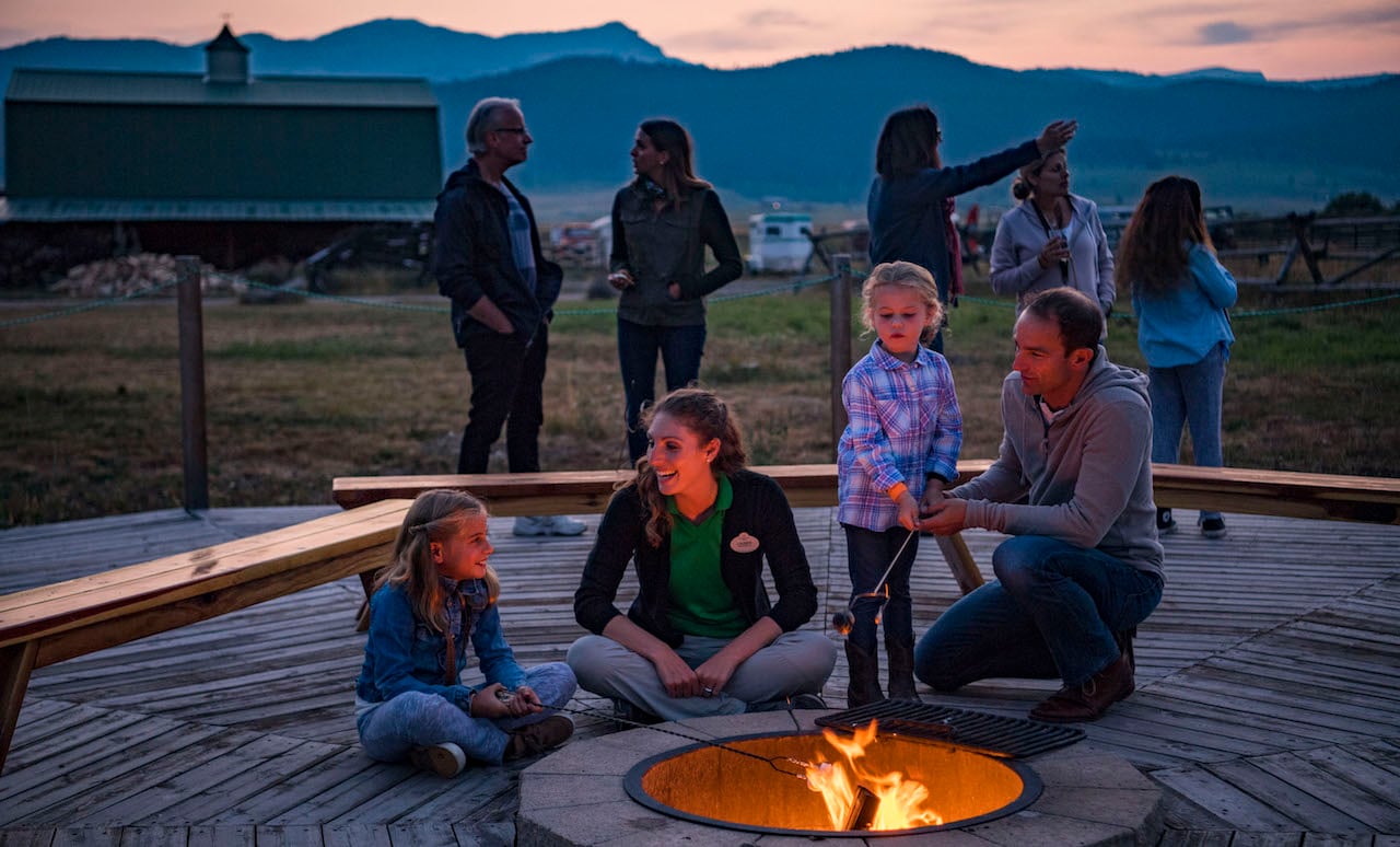 Families roast marshmallows in Montana with Adventures by Disney