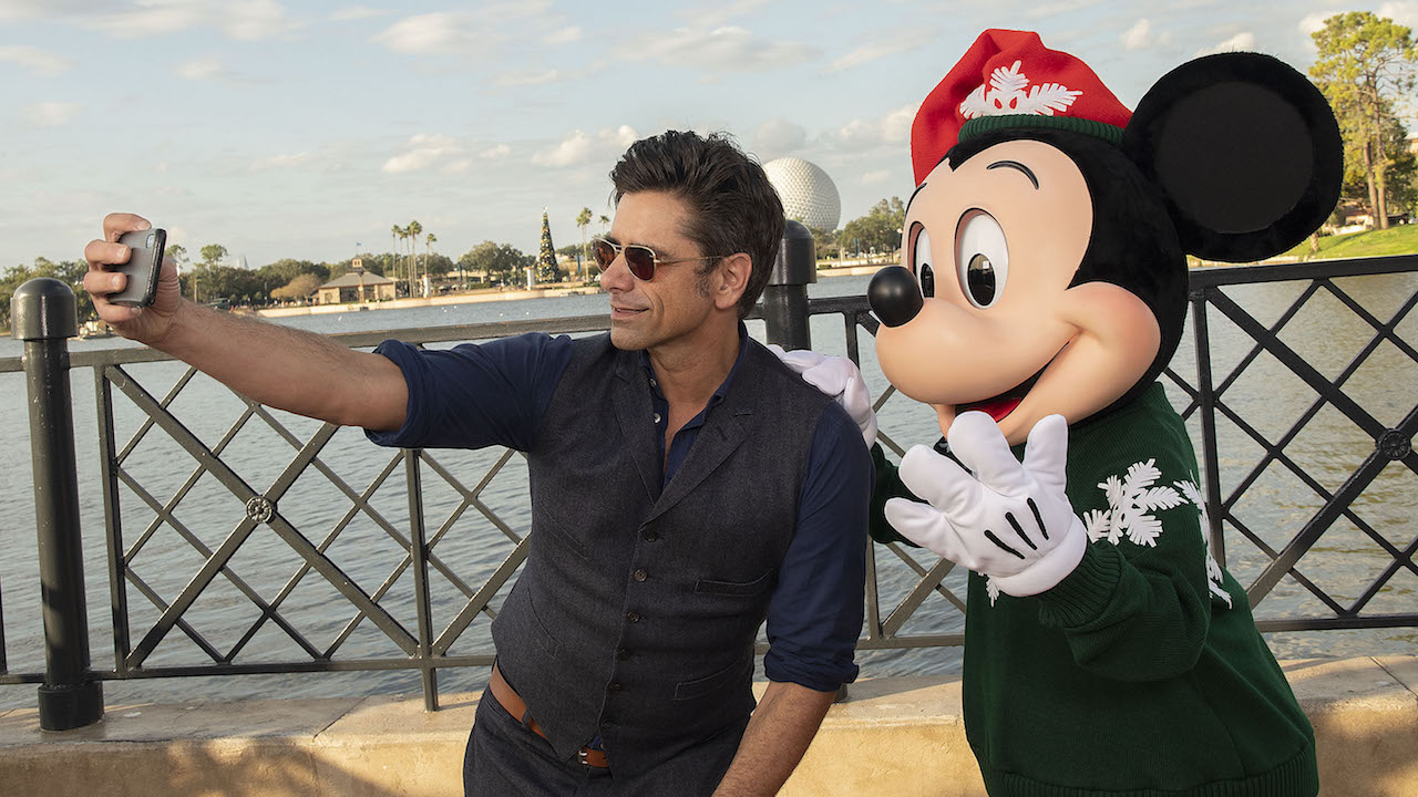 John Stamos poses with Mickey Mouse at Epcot at Walt Disney World Resort