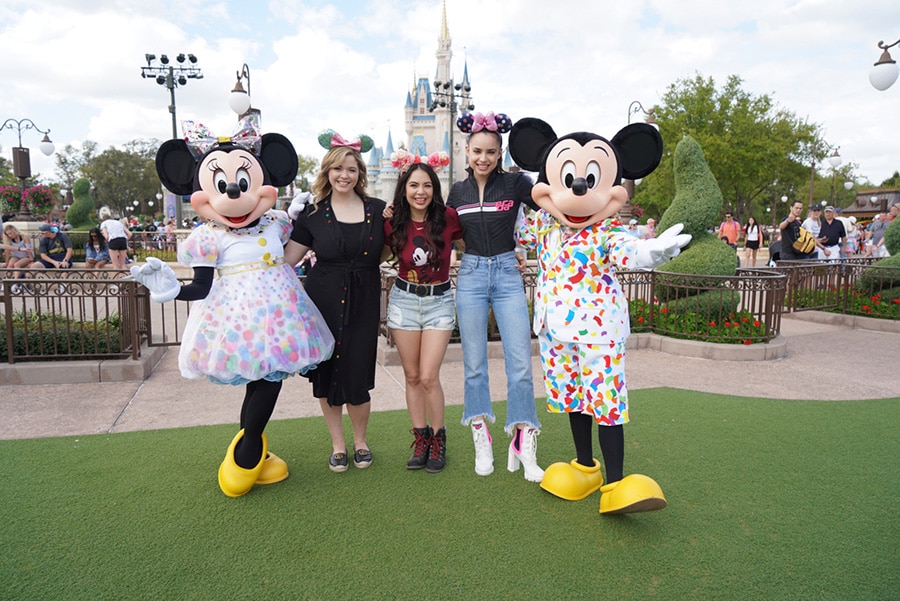 Sasha Pieterse, Janel Parrish, and Sofia Carson from the cast of Pretty Little Liars at the entrance to Magic Kingdom Park