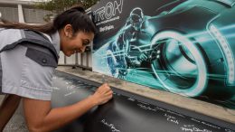 TRON attraction construction milestone at Magic Kingdom park - cast member signs name on first steel support columns for the new attraction