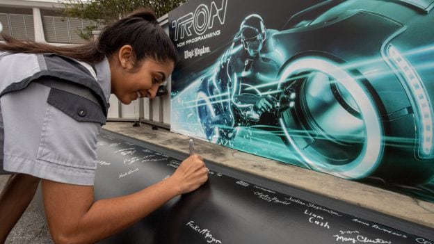 TRON attraction construction milestone at Magic Kingdom park - cast member signs name on first steel support columns for the new attraction