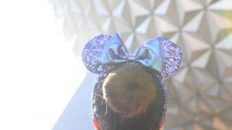 Purple Minnie Mouse ear headbands in front of Spaceship Earth