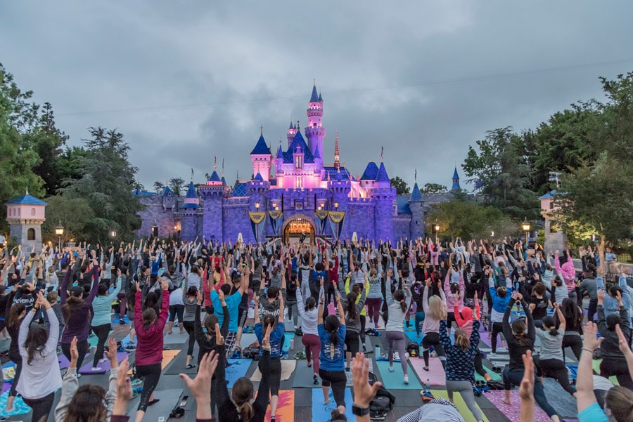 Cast members have a calming yoga session at Sleeping Beauty Castle at Disneyland Resort