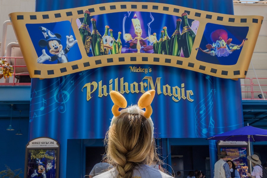 Girl wearing Donald Feet Headband in front of Mickey's Philharmagic