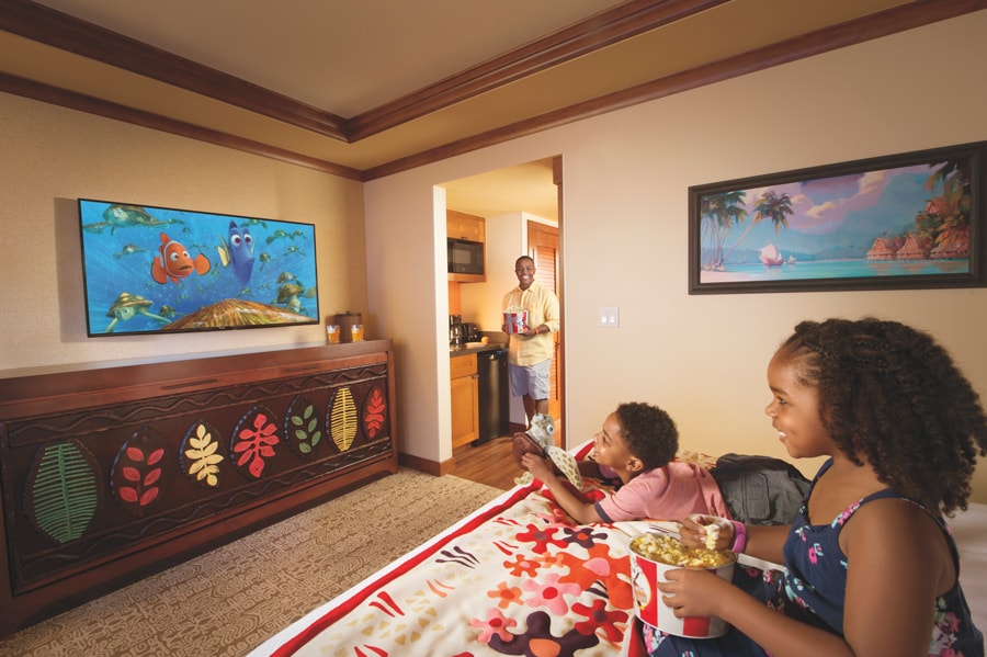 Family watches movie in a Disney Resort Hotel room