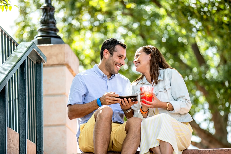 Couple sitting on the steps eating and drinking