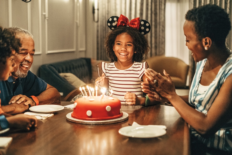 Family celebrating a birthday with a birthday cake