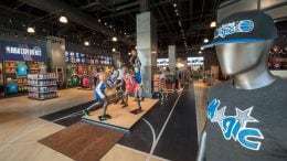 Interior of NBA Store inside NBA Experience at Disney Springs - close up of Orlando Magic hat and t-shirt