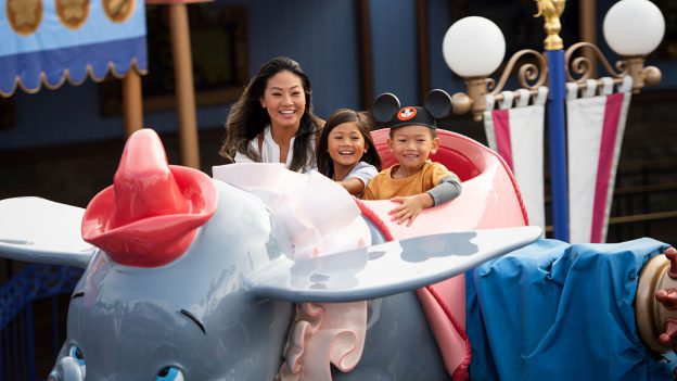 Family rides Dumbo at Disneyland park