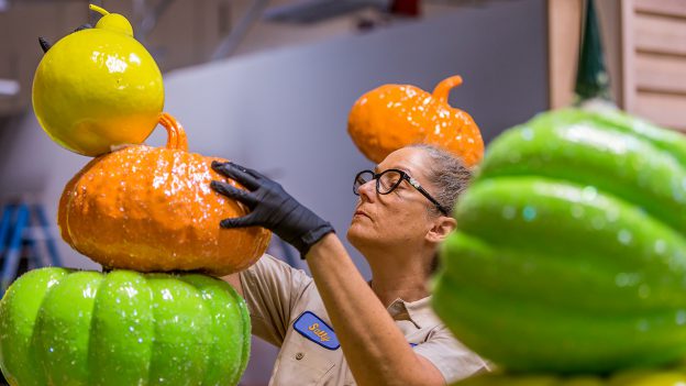Artist working on the pumpkins that decorate Downtown Disney District at Disneyland Resort